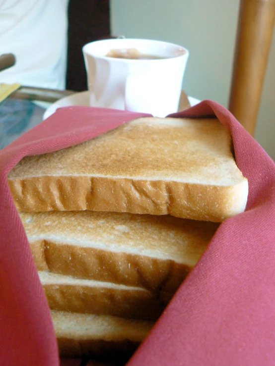 a stack of bread with a red cloth around it