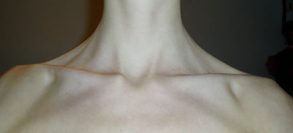 a close up of the neck and shoulder of a young man