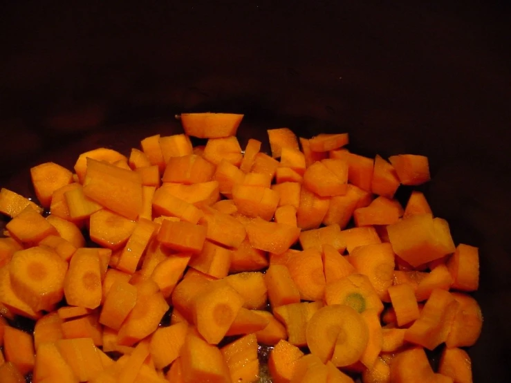 some carrots are cooking in a pan on the stove