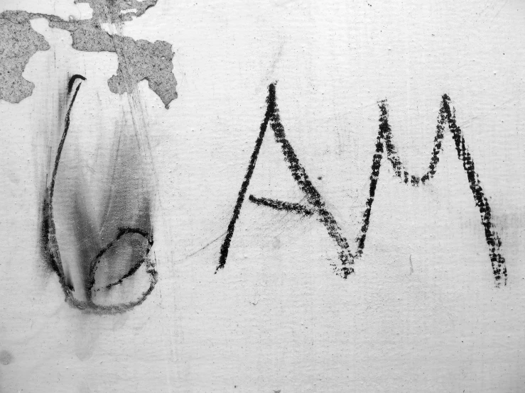 graffiti written on a white wall saying aa