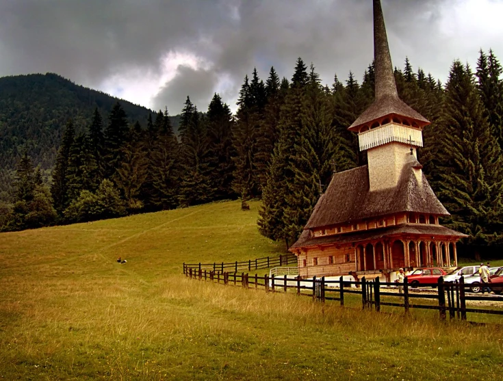 the brown church has a steeple on it's roof