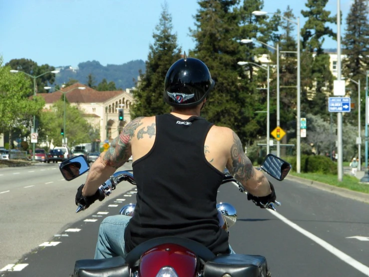 a man on a motorcycle, wearing a helmet and gloves