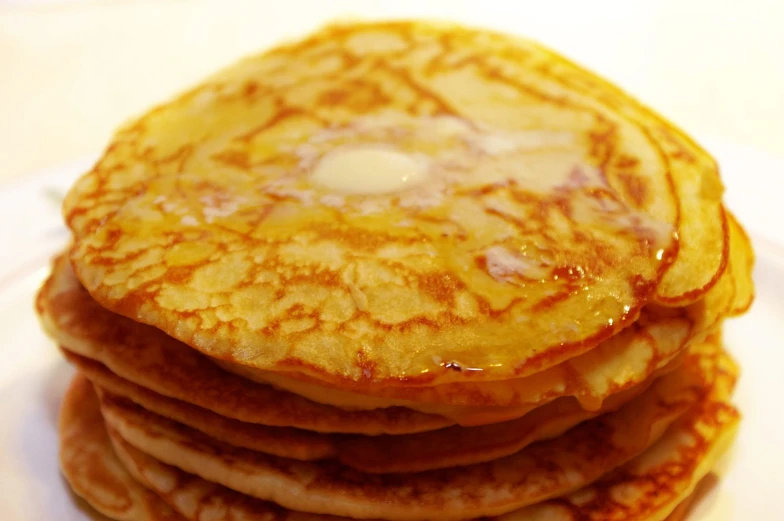 a stack of pancakes are topped with syrup