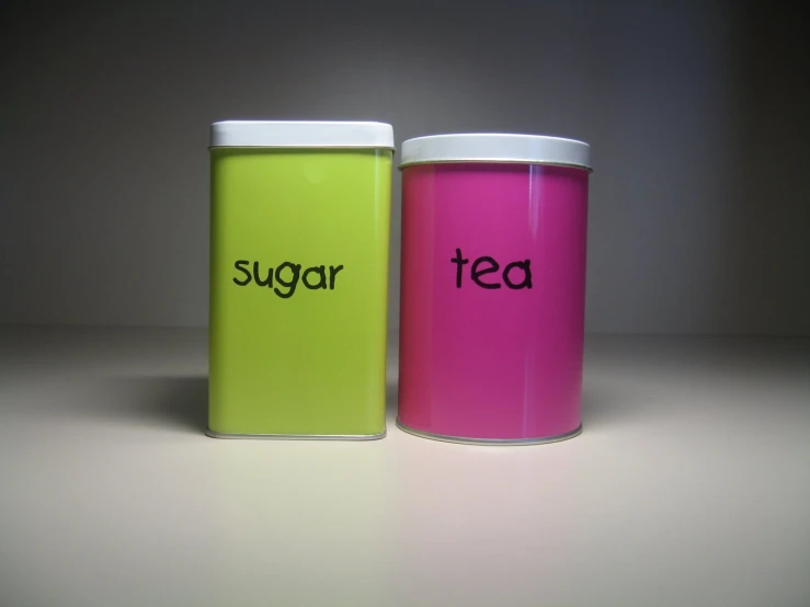 two colorful coffee mugs that say sugar and tea