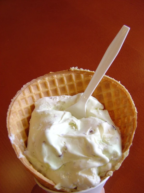 an ice cream waffle topped with a scoop of vanilla icecream