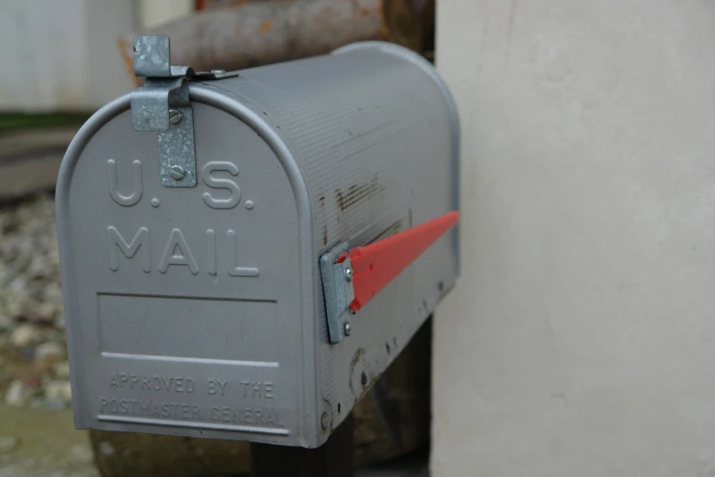 the gray mailbox has a red arrow in it