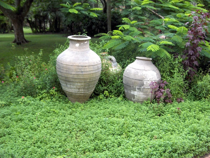 a number of vases in a flower bed