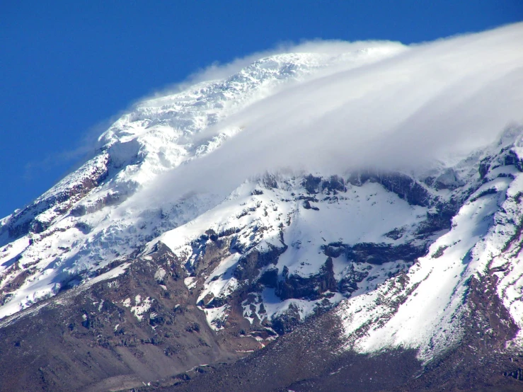 a huge cloud that is covering the mountain