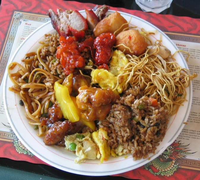a plate full of chinese noodles with sauce