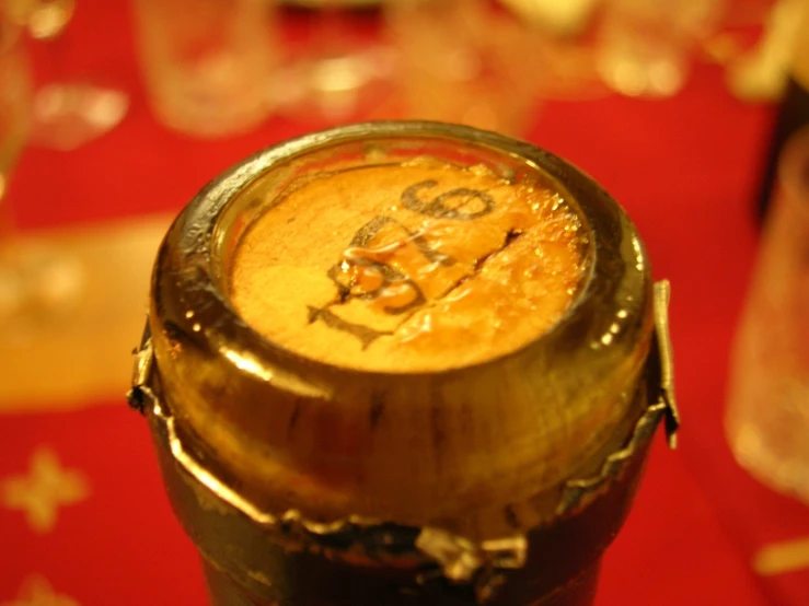 an empty wine bottle sitting on top of a red table