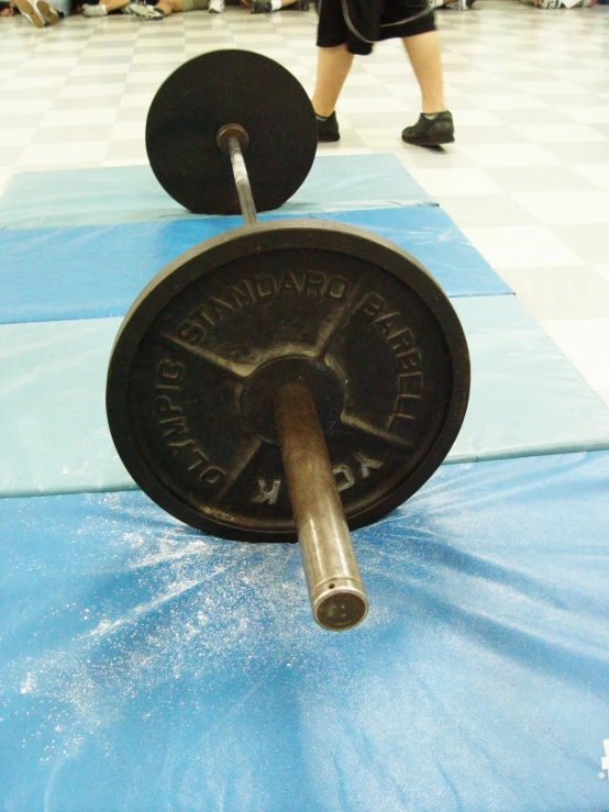 a large set of exercise gym equipment, the barbell is resting on the ground