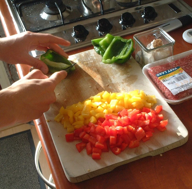 someone is  up some veggies on the table