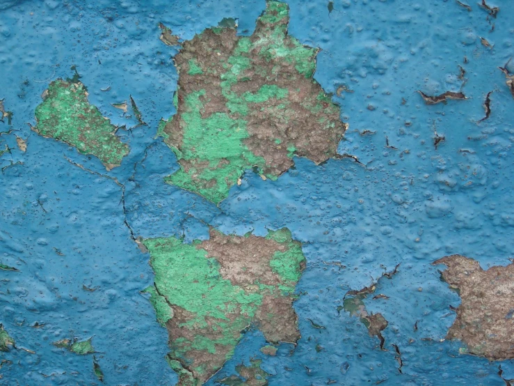 a blue background with green and brown paint