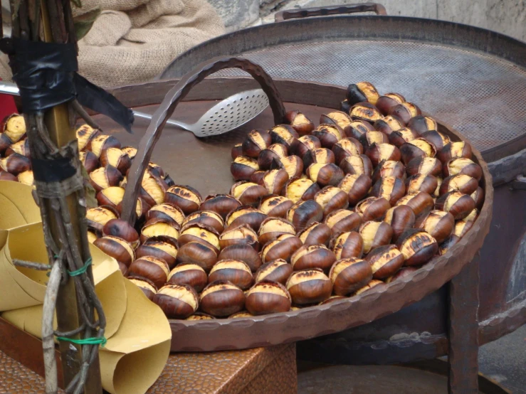 roasting chestnuts on a grill, in an iron pan
