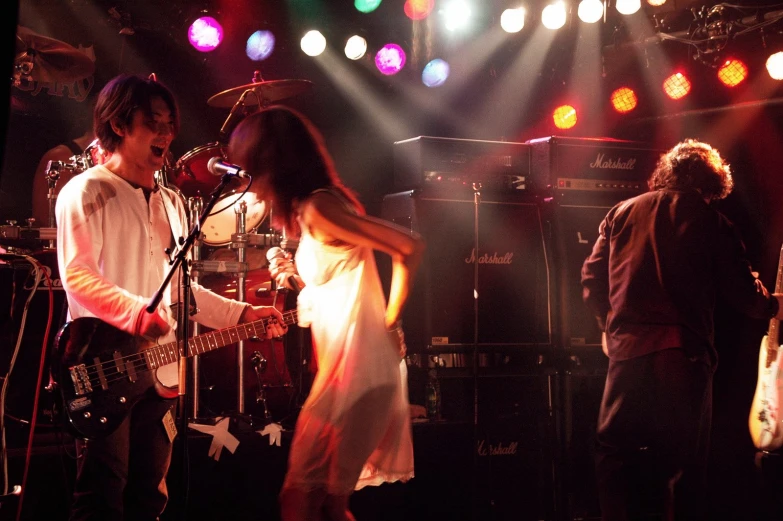 a person on stage playing with an electric guitar