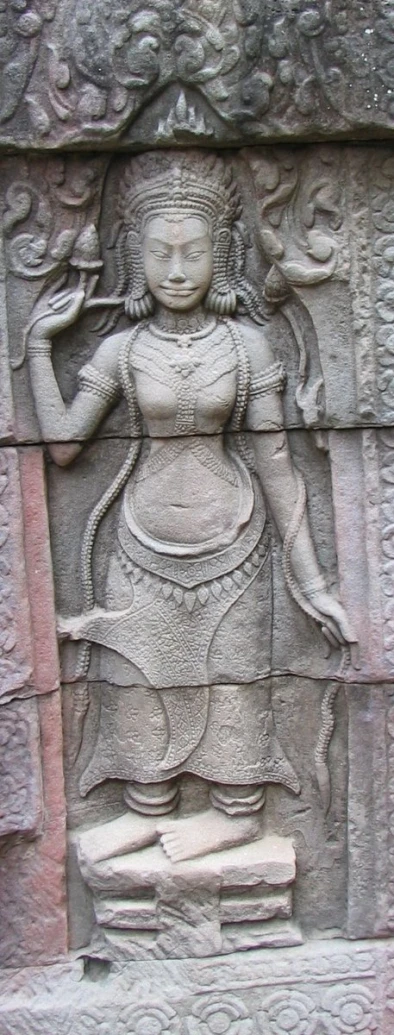 a large stone statue with a woman holding a bird