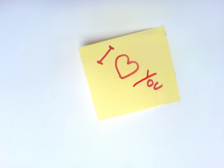 an i love you post it note stuck to a white table