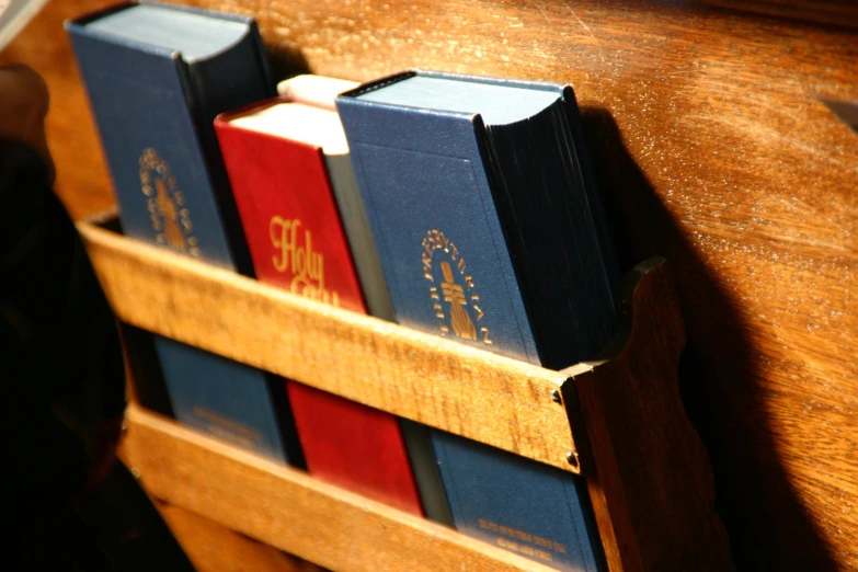 four books in wooden holders with writing on them