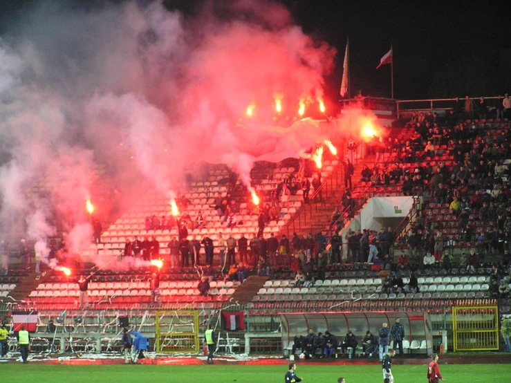 a group of people watching a soccer game in the stadium