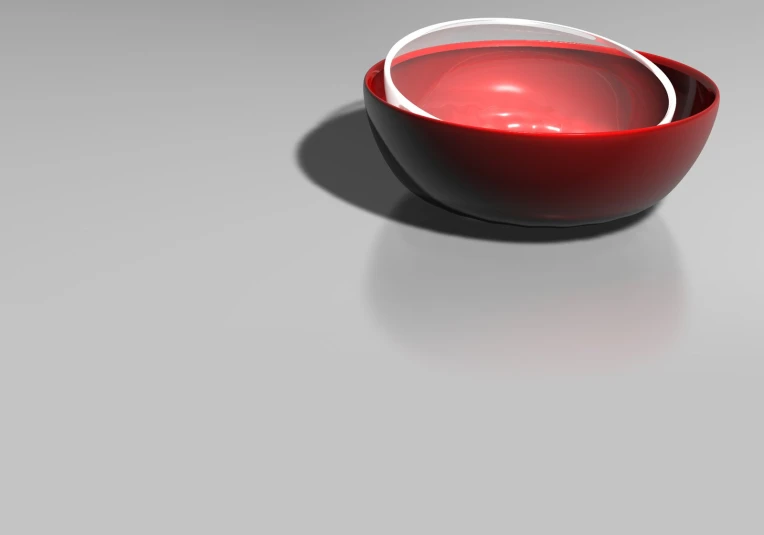 red glass bowl with white handles on gray background