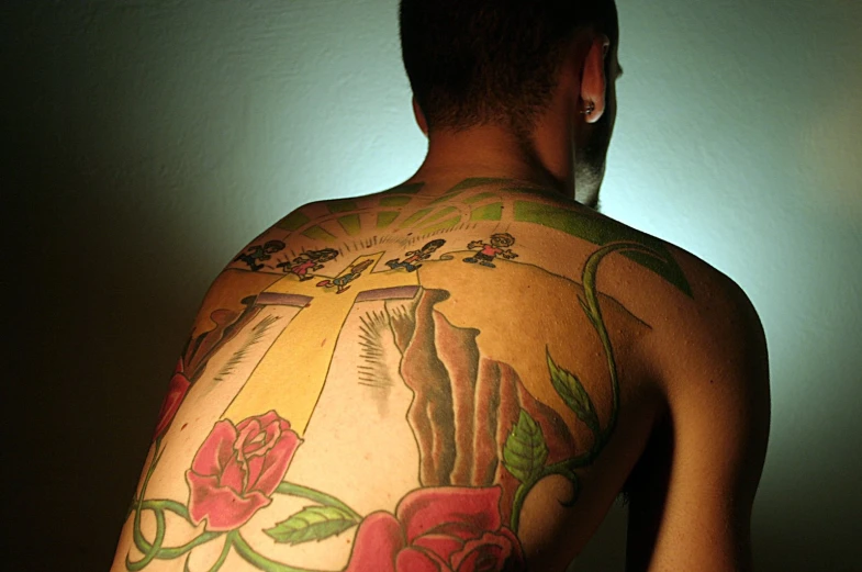 a man with a tattoo that is on his back