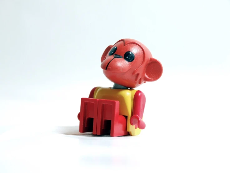 a red toy sitting on top of a white table