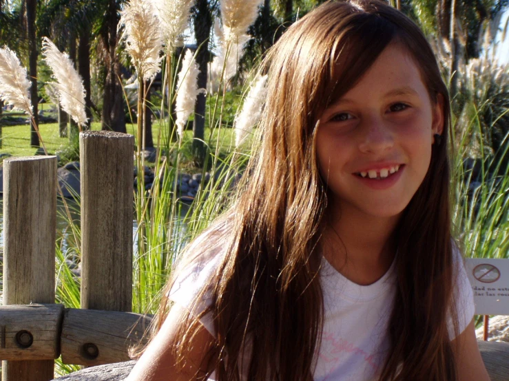 a girl smiles in front of an animal park