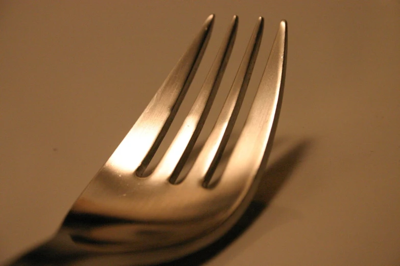 a close up of a fork on a table