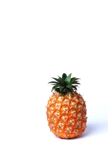 a pineapple is sitting on a white surface