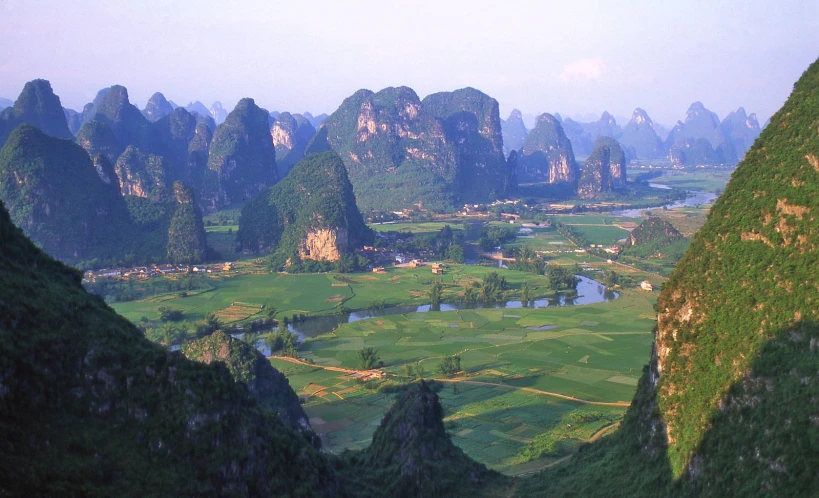 mountains and valleys surrounded by green fields