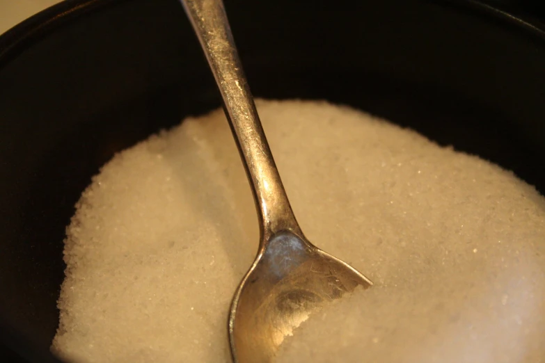 there is a spoon that has some sugar in it