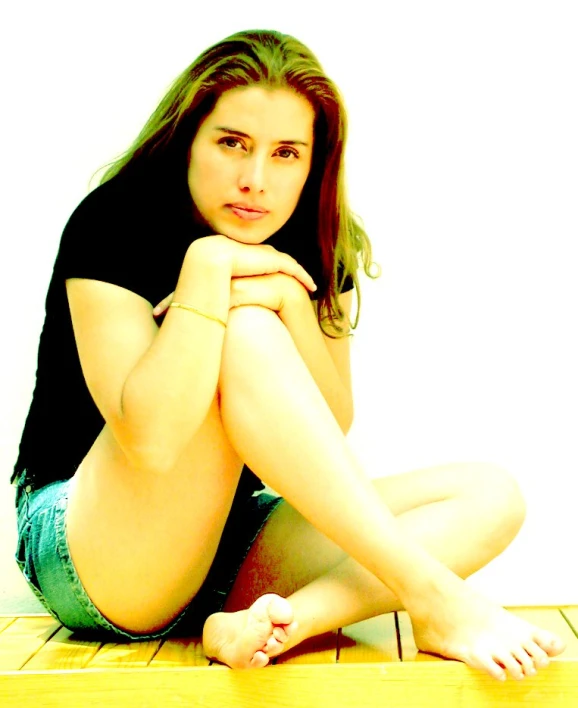 a woman in a blue shorts sitting on the floor