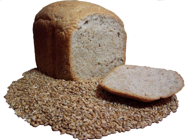 a loaf of bread next to a bowl of grain