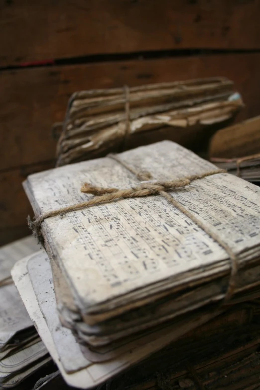 an old notebook tied up to a wooden desk