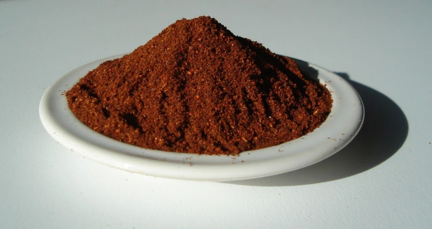 a small plate filled with a pile of cinnamon