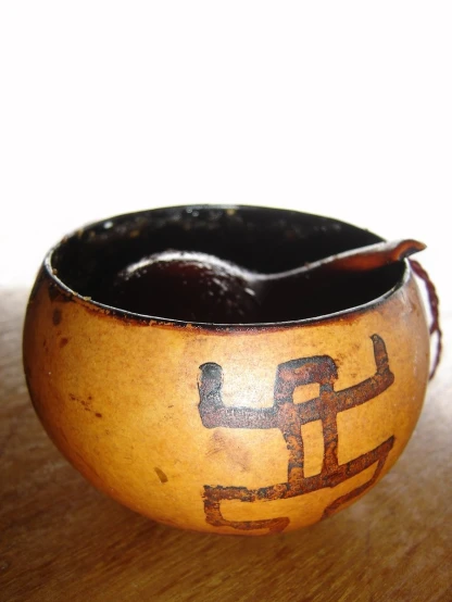 a bowl with carvings on it on a table