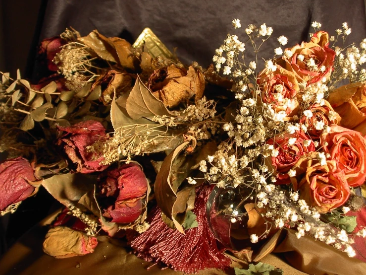 an assortment of flowers on a brown cloth