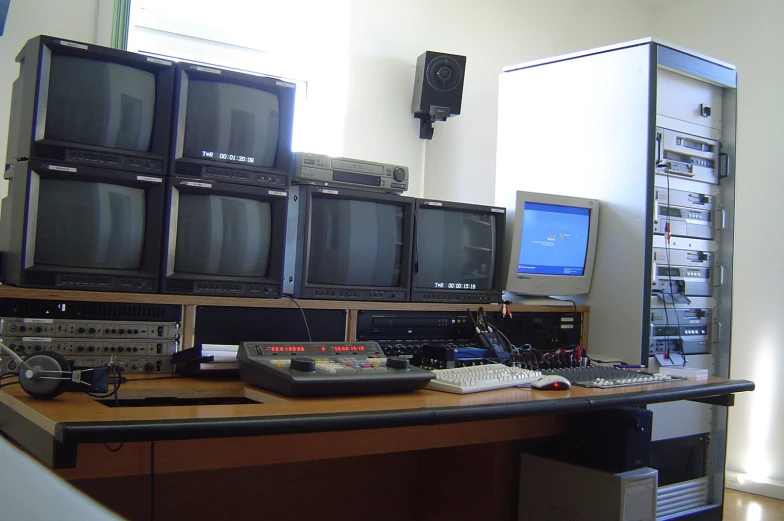 an old control room with old televisions on the desk