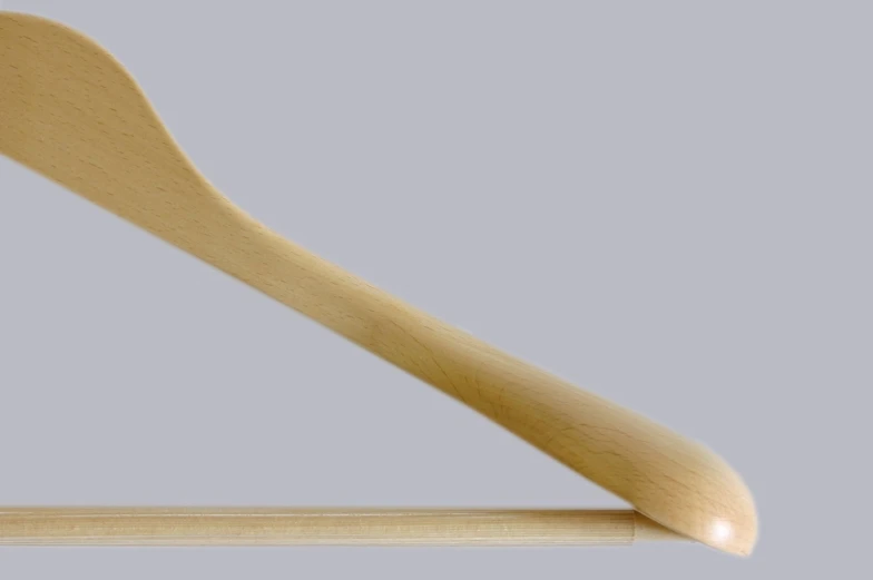 a wooden spoon sits on a piece of wood