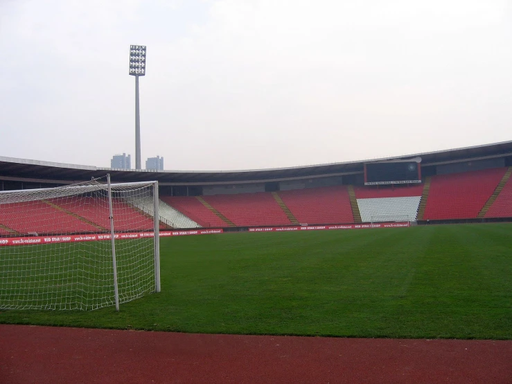 an empty soccer field with a football goal in the middle of it