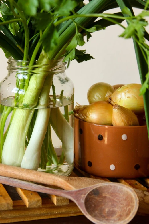 some onions and other vegetables are in a vase