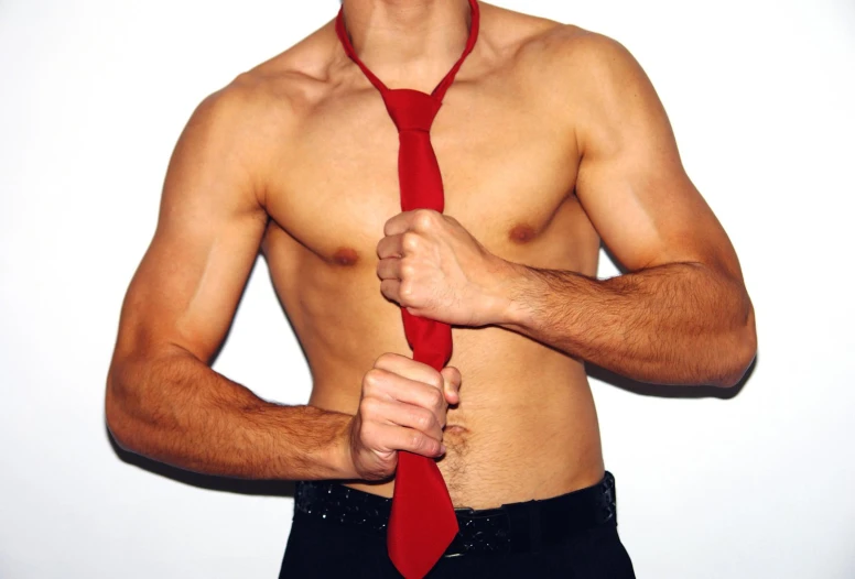 a shirtless man in a red tie