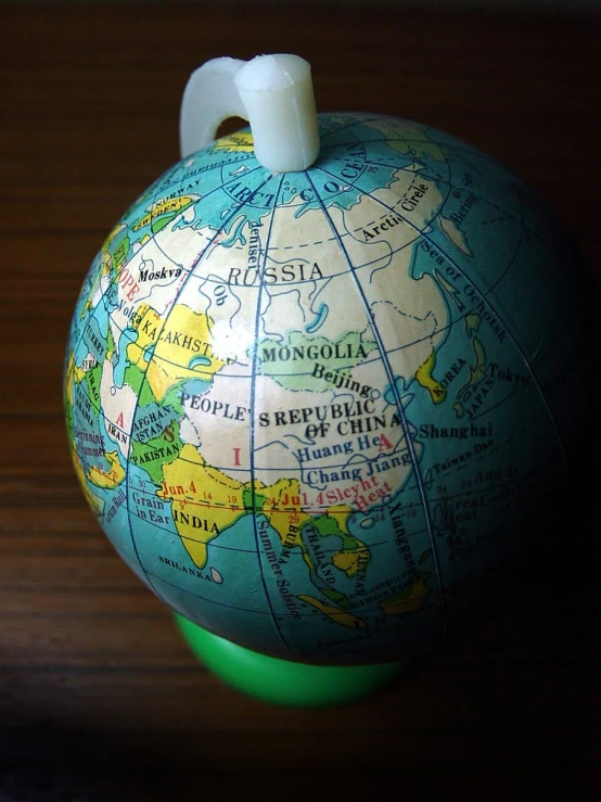 a globe ball with a tooth brush stuck to it