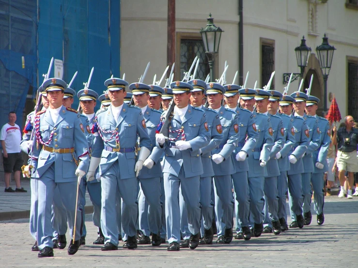 people standing and walking in formation at a military ceremony