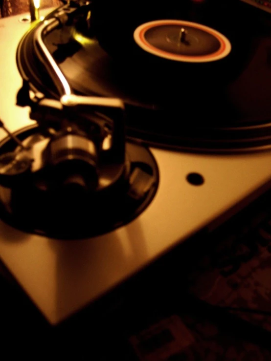 a record player is on top of a turntable with the light on