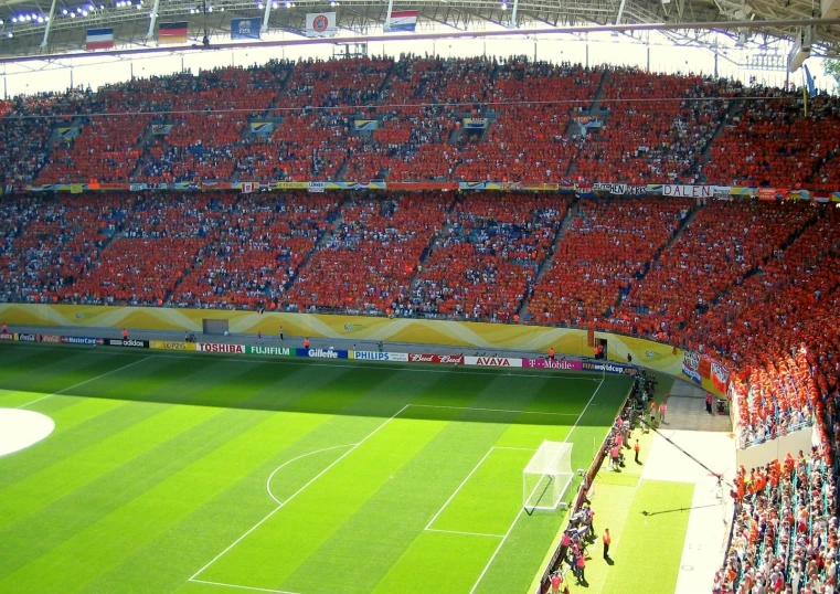 a large stadium is full of people watching soccer