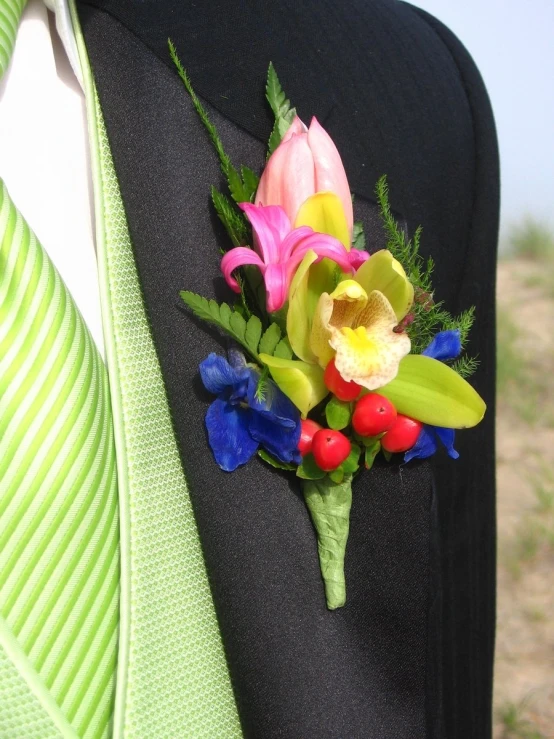 the lapel flower is attached to a black suit