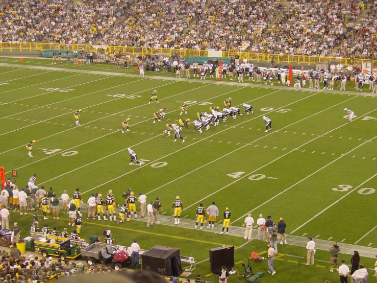 a wide view of the stadium filled with people playing football