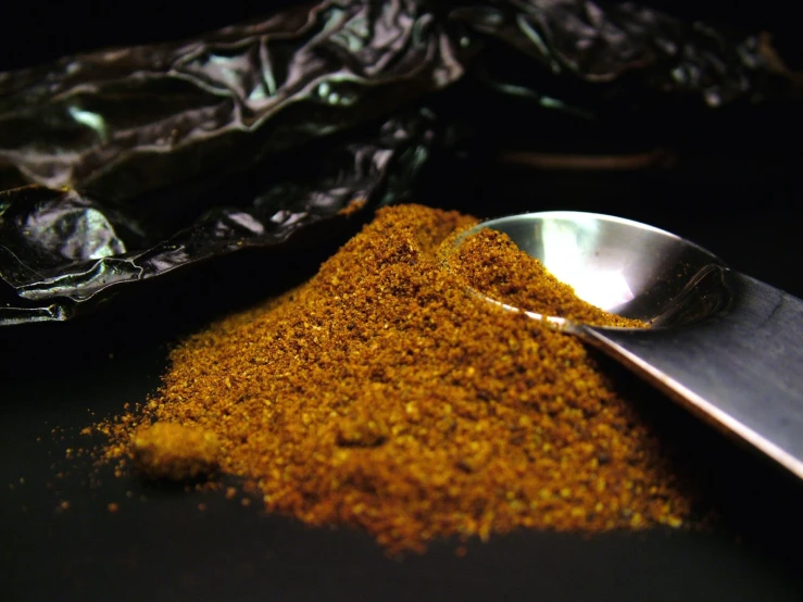 spices, spoon and plastic bag on table