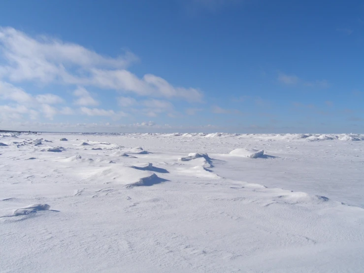 a snowboarder riding down a hill in the middle of winter